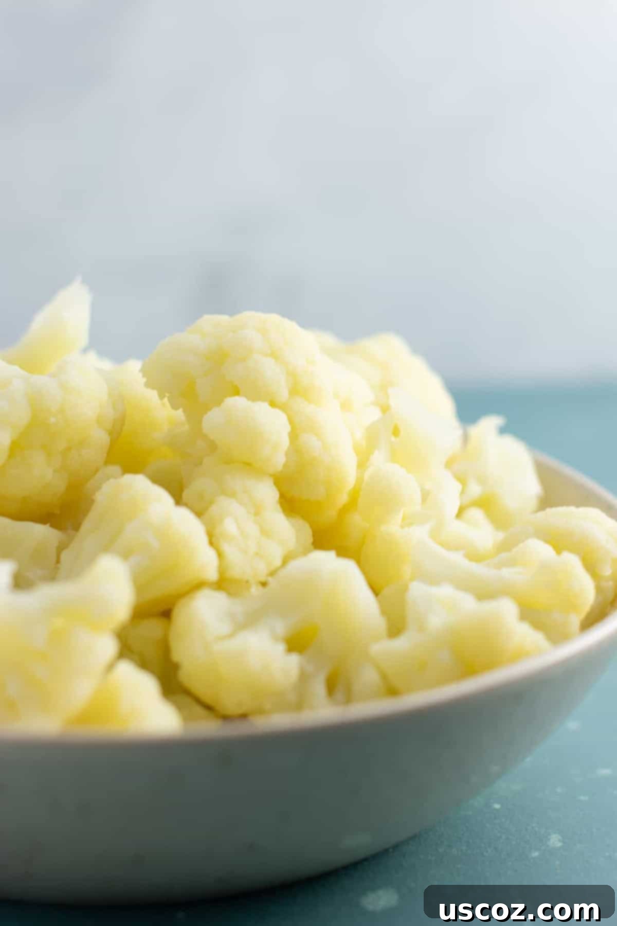 Perfectly Steamed Cauliflower 2 Bowl of perfectly steamed cauliflower florets, ready to be served or used in a recipe.