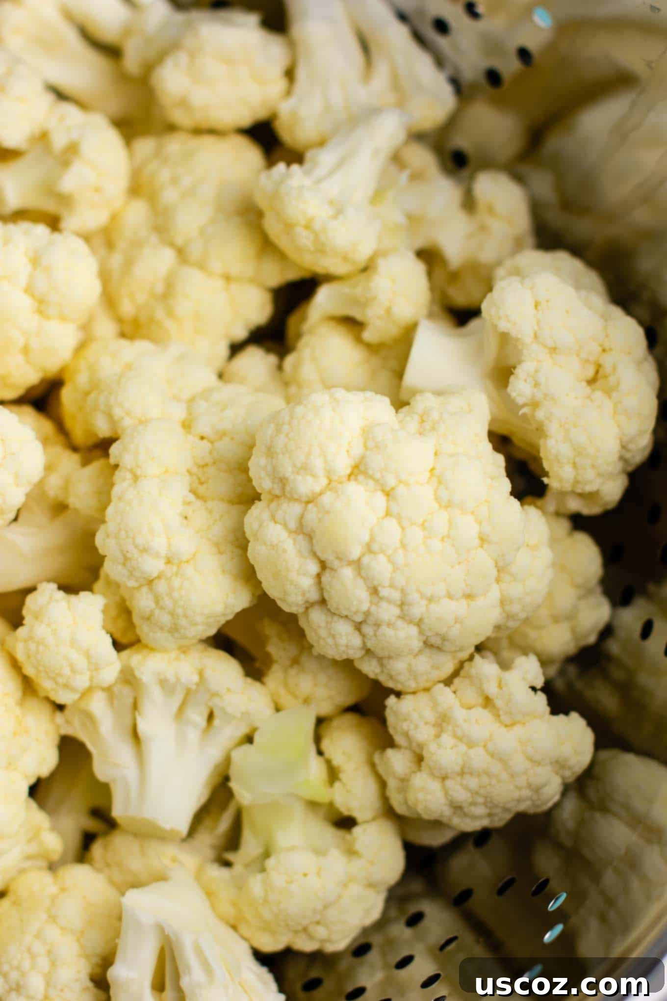 Perfectly Steamed Cauliflower 3 Close-up of fresh, raw cauliflower florets, prepped for steaming.