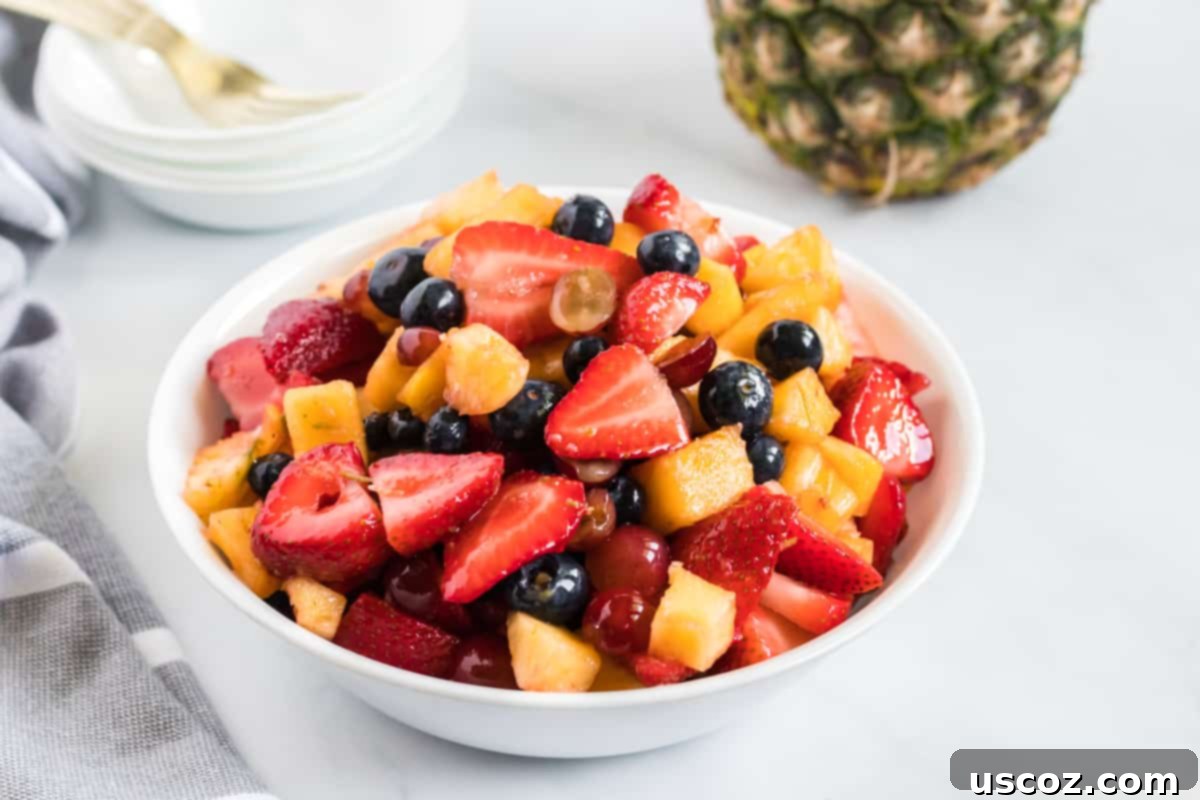 Vibrant Fruit Medley 9 fruit salad in a small white serving bowl