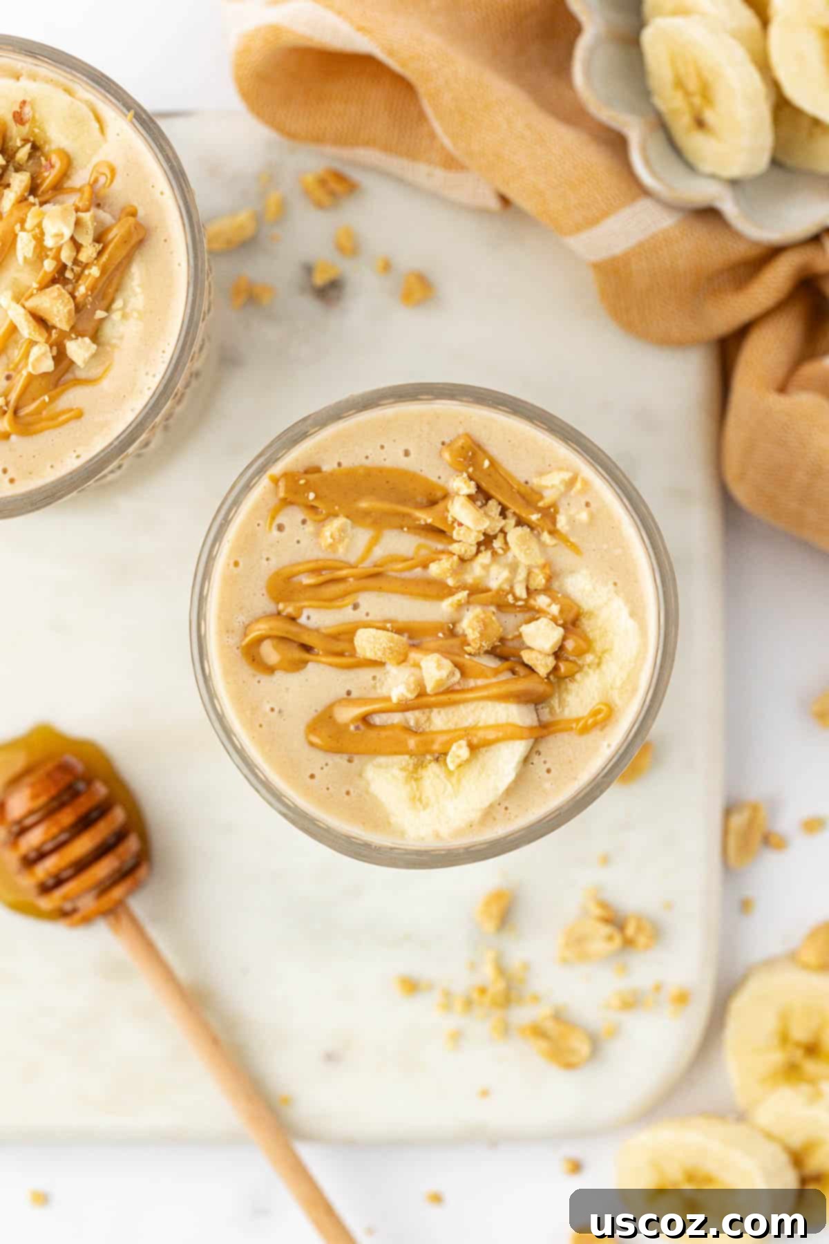 Peanut Butter Banana Dream 5 peanut butter banana smoothie topped with drizzled peanut butter and peanuts