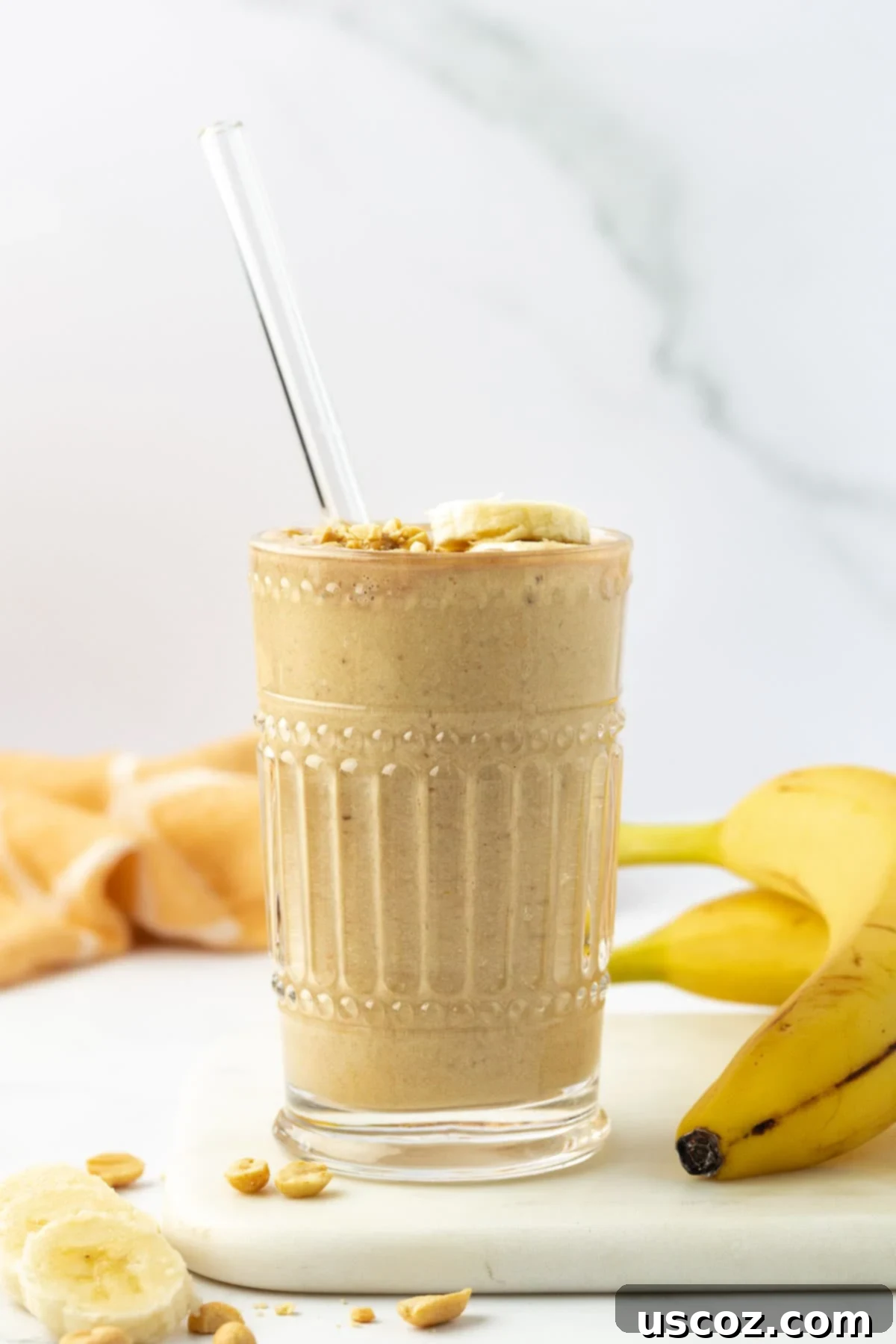 Peanut Butter Banana Dream 6 peanut butter banana smoothie in a glass with a straw