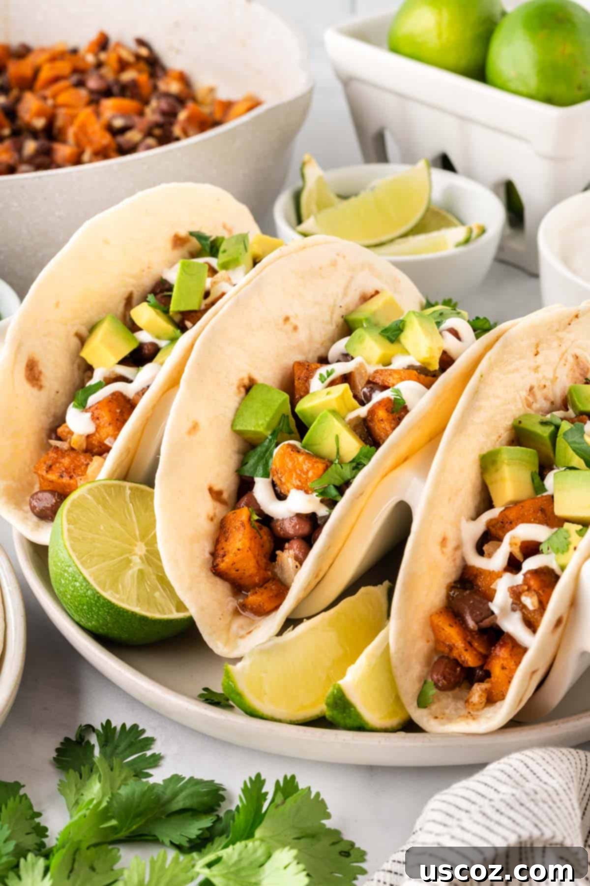 Sweet Potato Fiesta 2 sweet potato tacos topped with sour cream and diced avocado