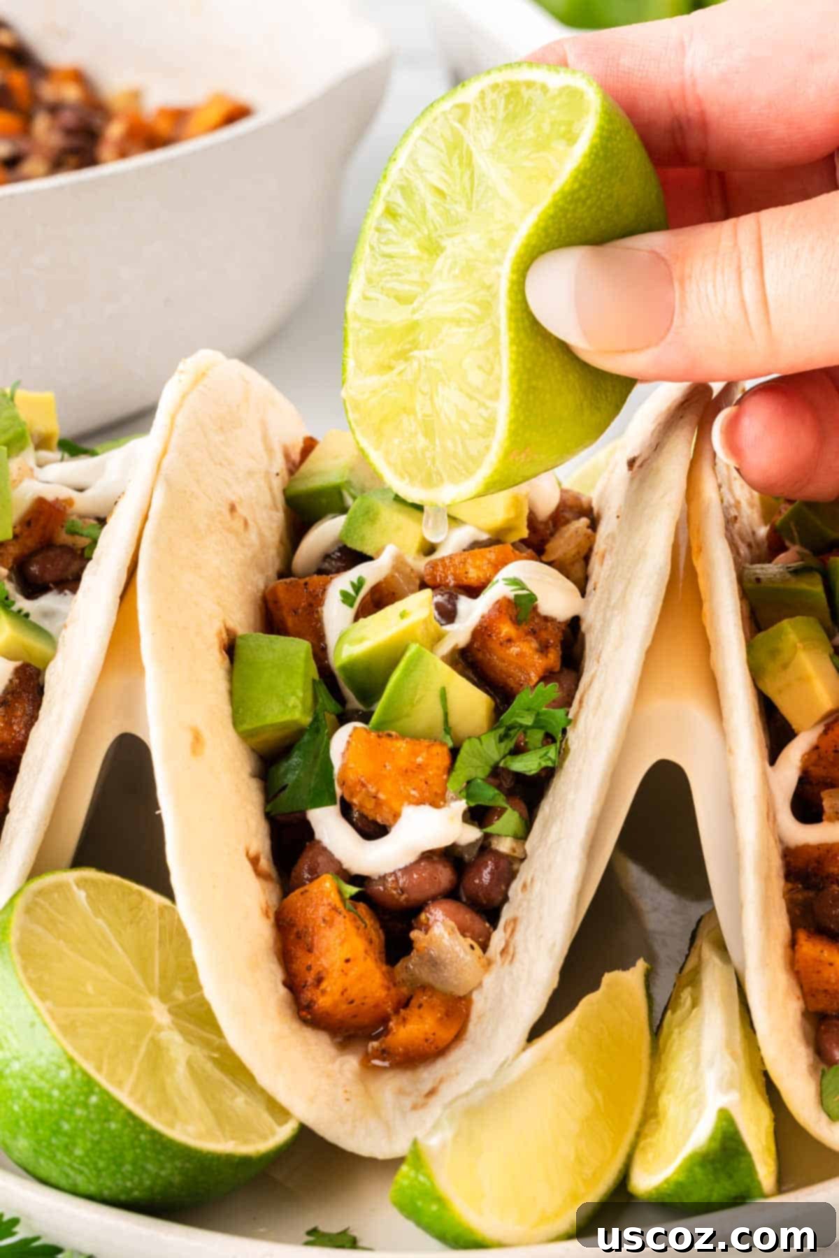 Sweet Potato Fiesta 16 squeezing fresh lime juice onto a sweet potato taco