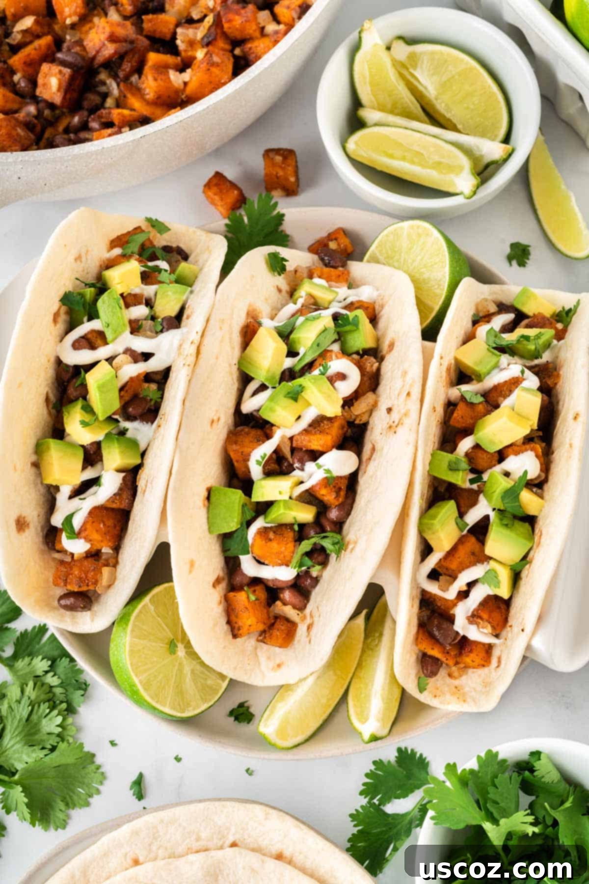 Sweet Potato Fiesta 18 sweet potato tacos topped with sour cream and diced avocado