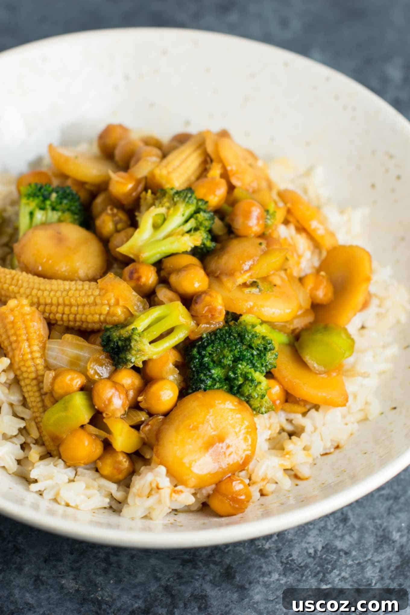 Vegan Chickpea Stir fry Bowl 4 This easy vegan chickpea stir-fry bowl with brown rice is packed with healthy vegetables like water chestnuts and baby corn, giving it an authentic takeout feel. #vegan #veganstirfry #chickpeastirfry #vegandinner