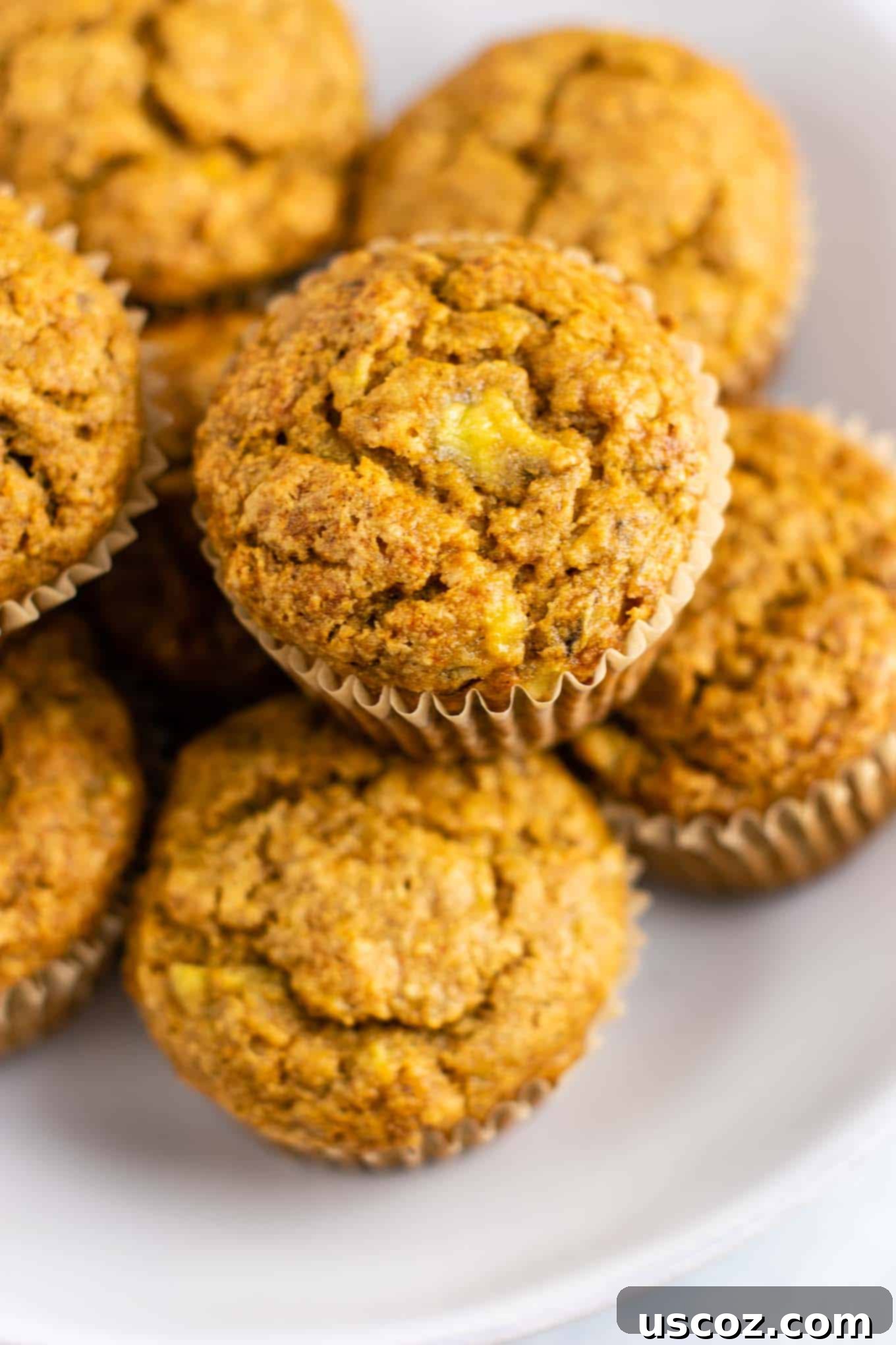 Moist Vegan Banana Muffins 4 a stack of easy vegan muffins on a cooling rack