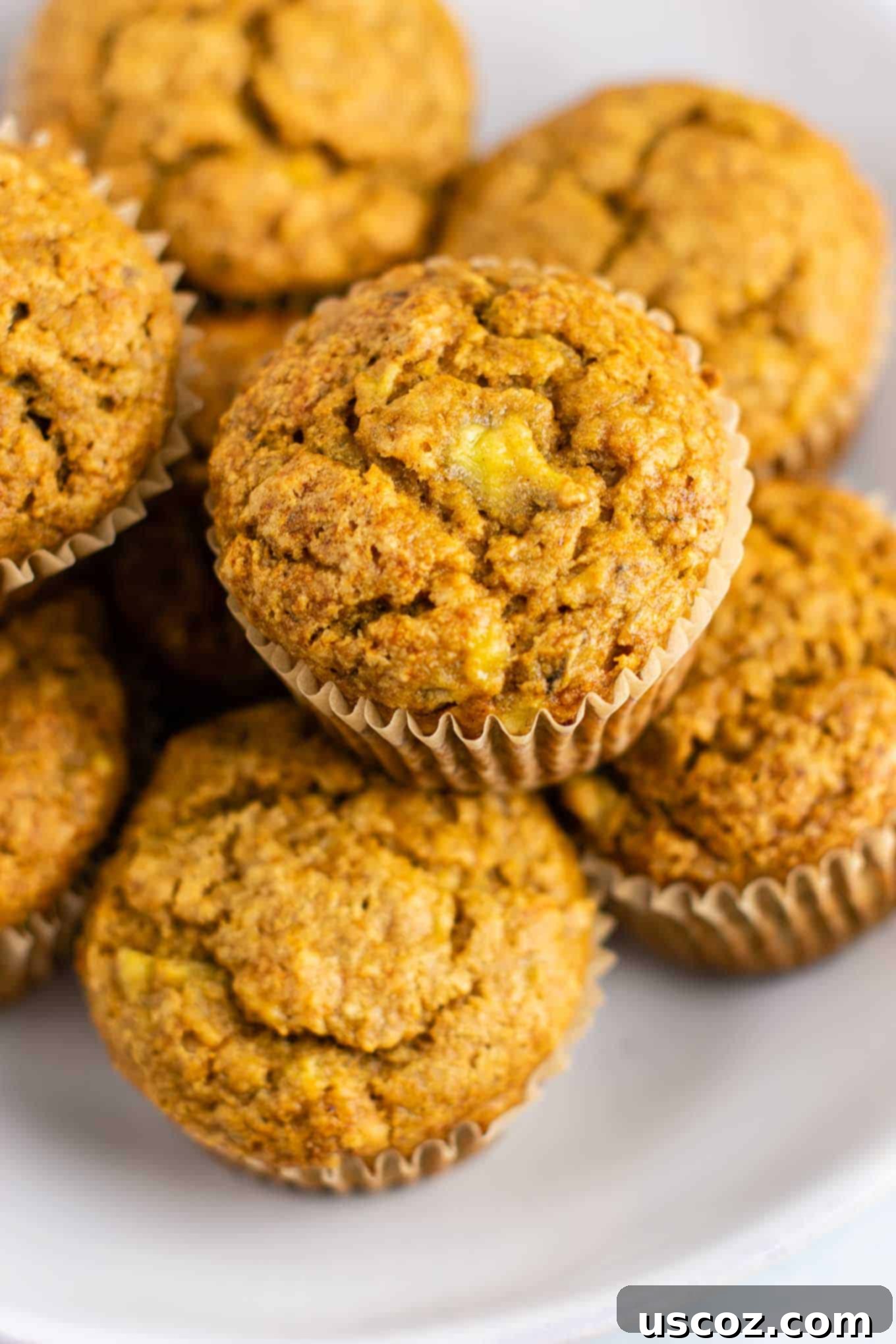 Moist Vegan Banana Muffins 6 a plate of vegan breakfast muffins next to a glass of milk
