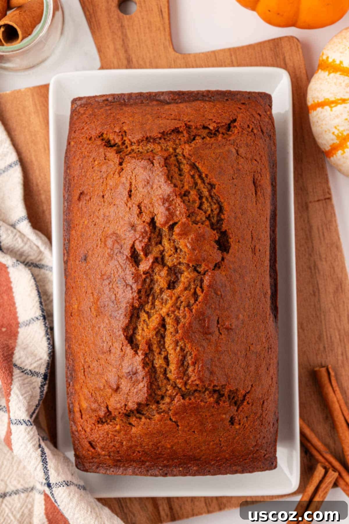 Freshly baked pumpkin bread with a golden-brown crust, just out of the oven