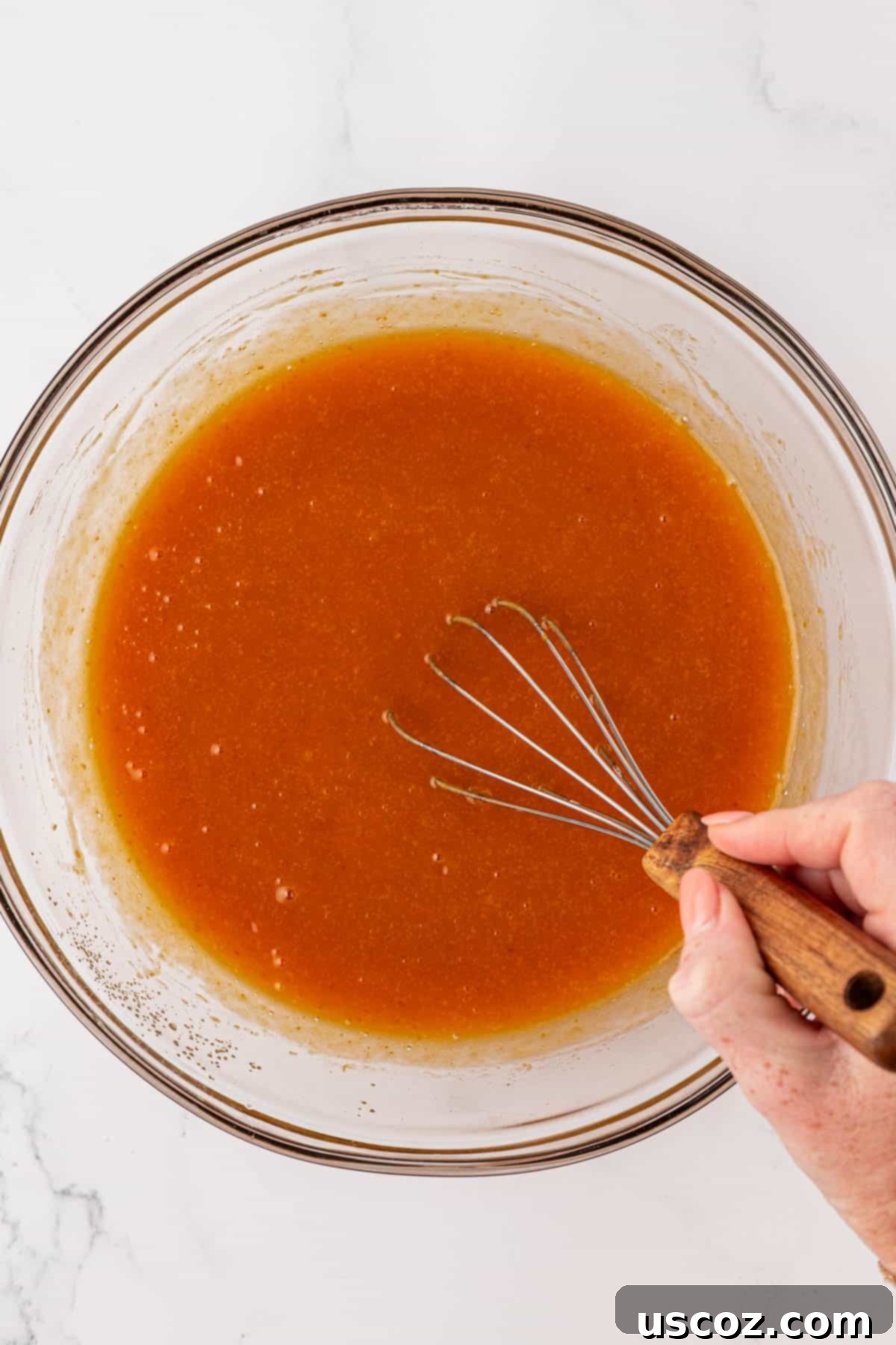 Wet ingredients for pumpkin bread whisked together until smooth and creamy