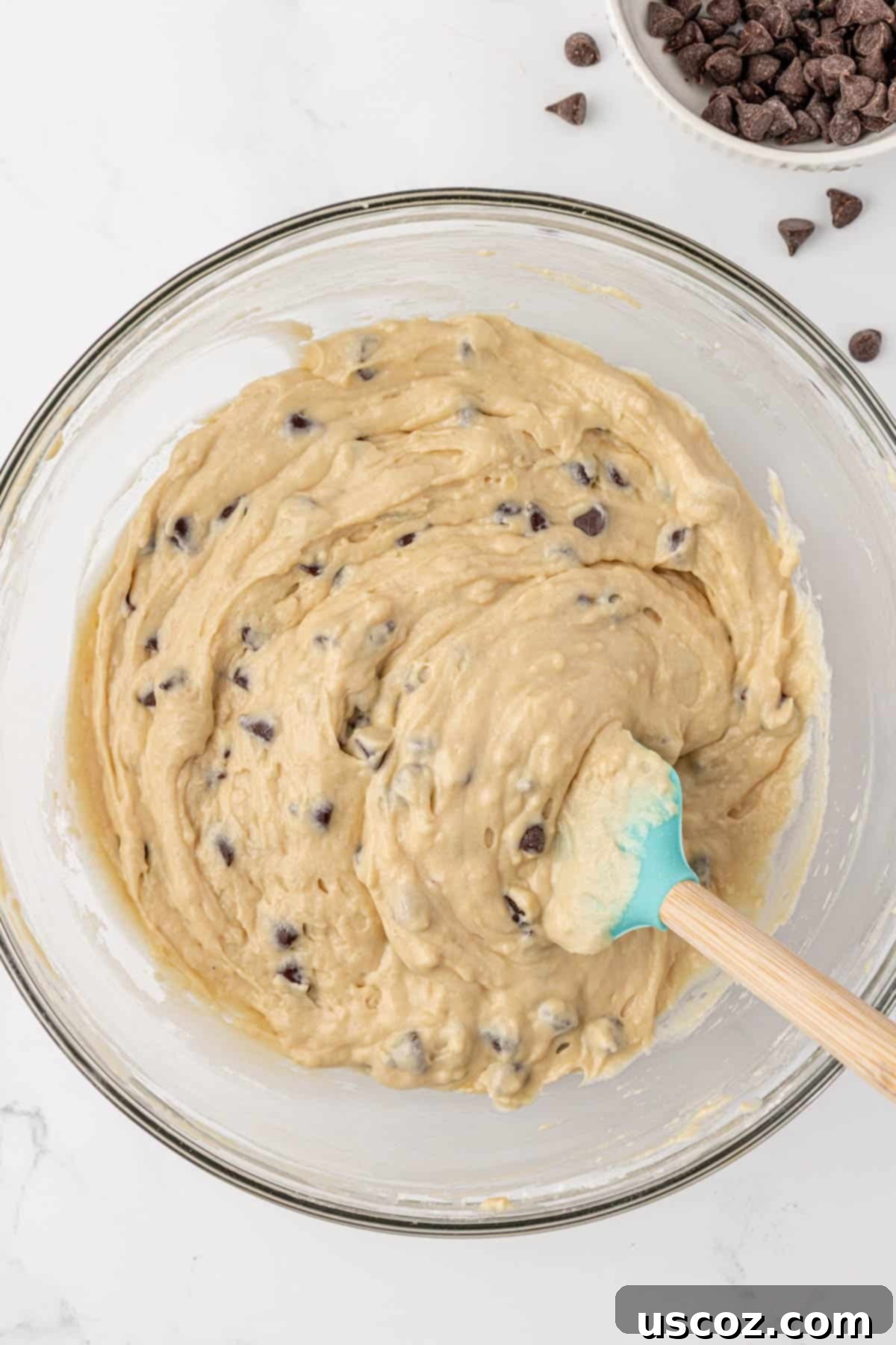 Greek yogurt quick bread batter in a mixing bowl with chocolate chips folded in