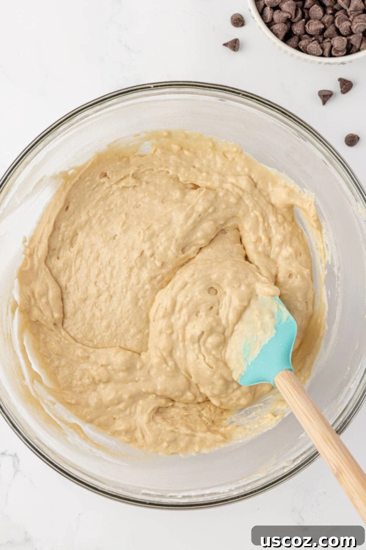 Quick bread batter after being gently stirred, showing a few dry streaks
