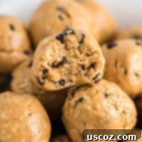 Classic peanut butter chocolate chip energy ball with a bite taken out, showing oats and chocolate chips