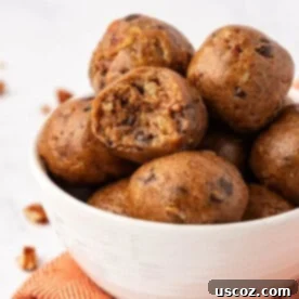 Festive pecan pie energy bites, showcasing chopped pecans and a hint of glaze, perfect for holidays