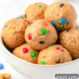 Colorful M&M Cashew Crunch energy bites scattered with mini M&M candies