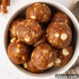 White Chocolate Pumpkin Spice Energy Bites garnished with white chocolate chips and spices