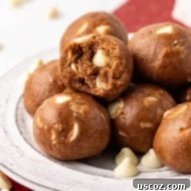 Festive gingerbread energy bite with a bite taken out, showing its spiced interior, ideal for holiday snacking