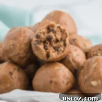 Rich, dark chocolate protein balls stacked in a small bowl, ready to eat