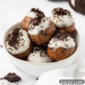 Cookies and cream protein balls with visible crushed dark cookies and white cream