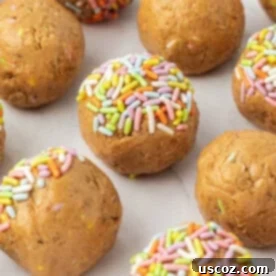 Festive birthday cake protein balls covered in colorful sprinkles, in a celebratory setting