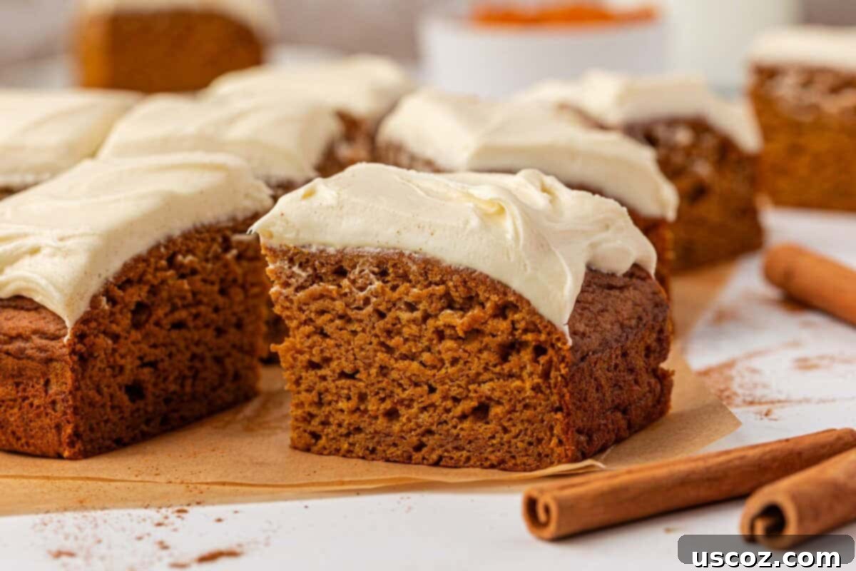 pumpkin snack cake with cream cheese frosting, garnished with a sprinkle of cinnamon