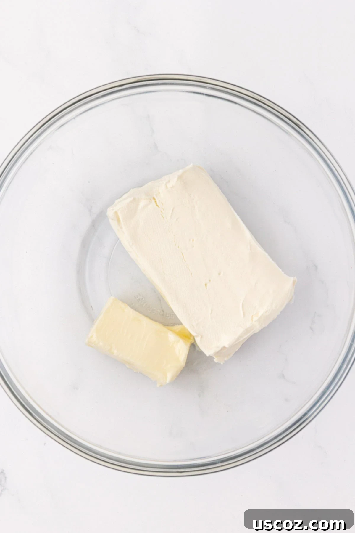 Softened butter and cream cheese in a mixing bowl, ready for frosting preparation