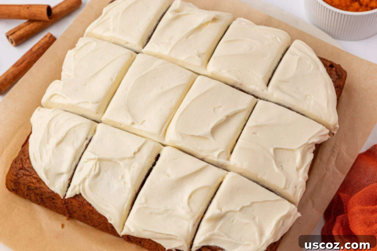Pumpkin snack cake sliced into 12 squares, ready to be served
