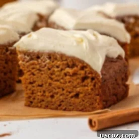 slice of pumpkin snack cake with cream cheese frosting