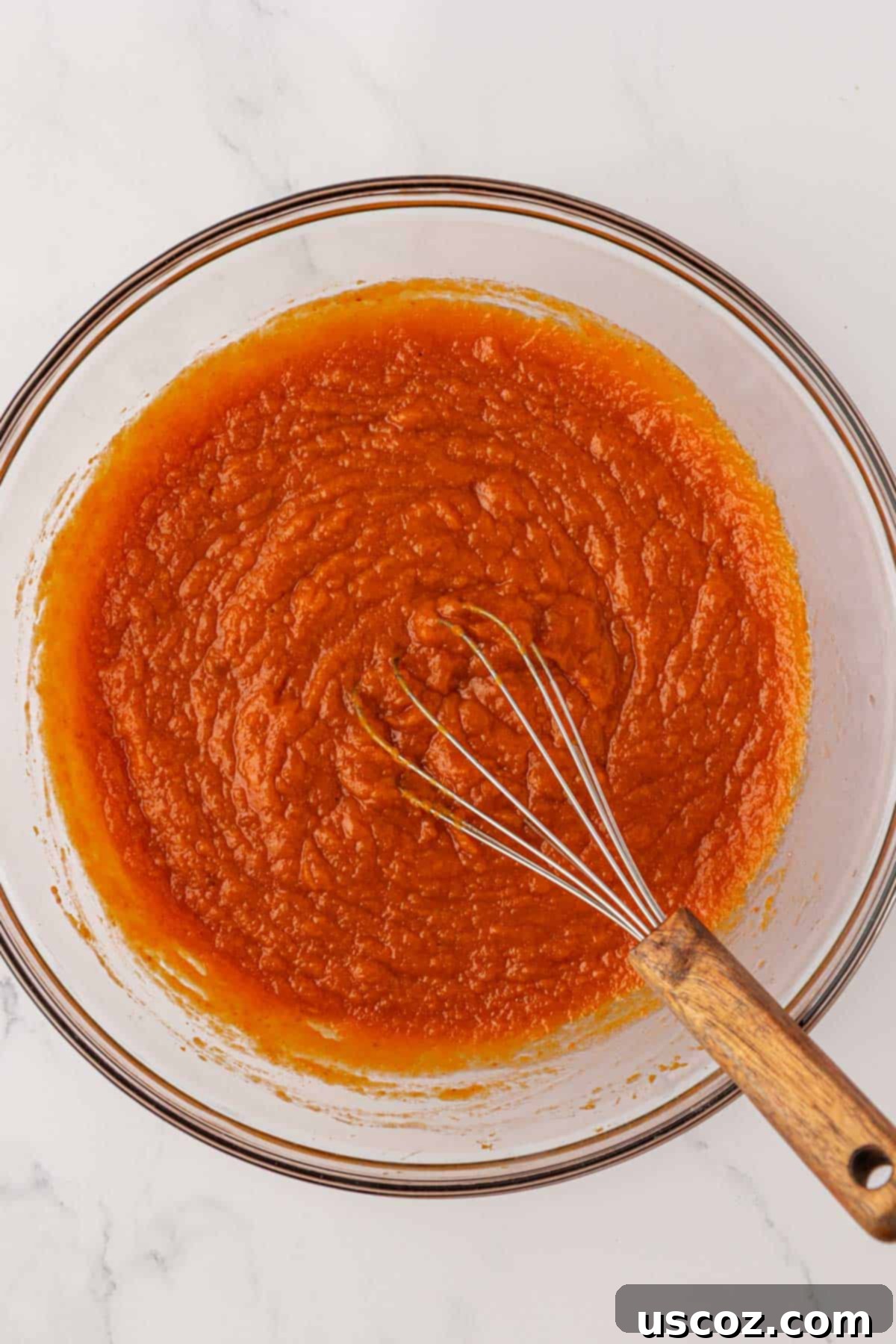 Wet ingredients for pumpkin snack cake mixed together in a bowl