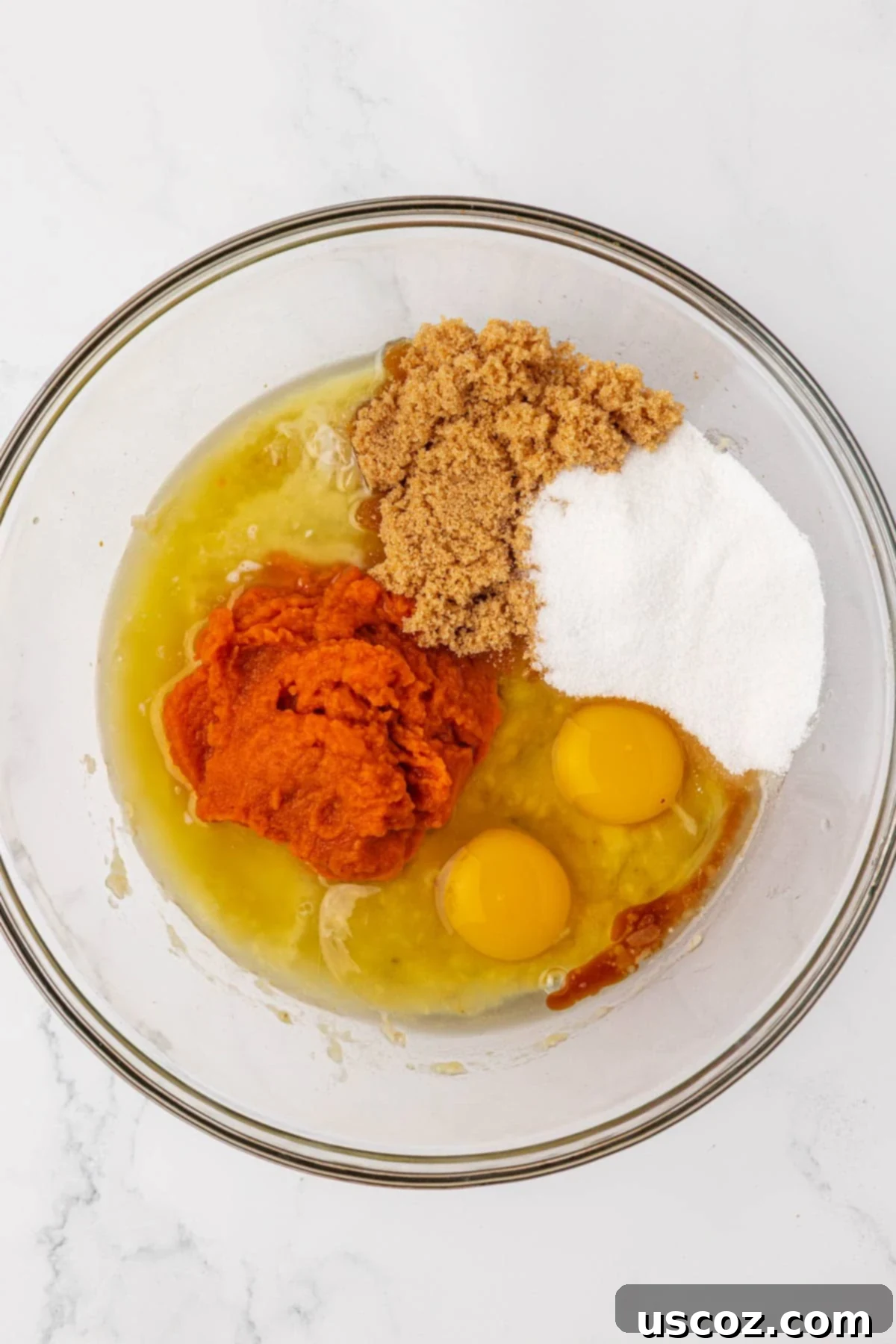 Golden Pumpkin Banana Muffins 9 wet ingredients in a mixing bowl before whisking