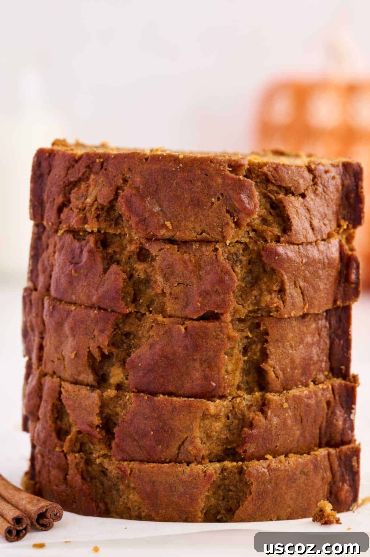 Slices of pumpkin banana bread stacked high, ready to be enjoyed