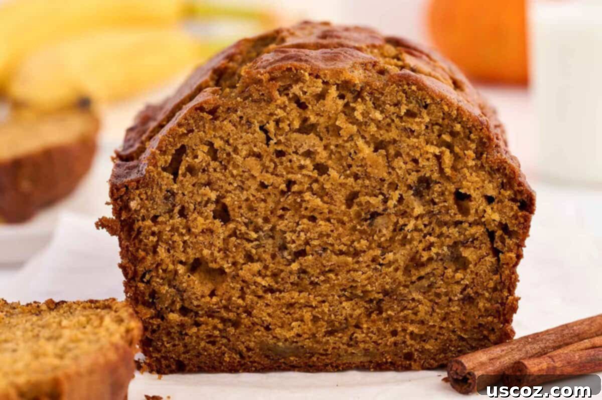 A perfectly baked pumpkin banana bread loaf, ready to be sliced and served