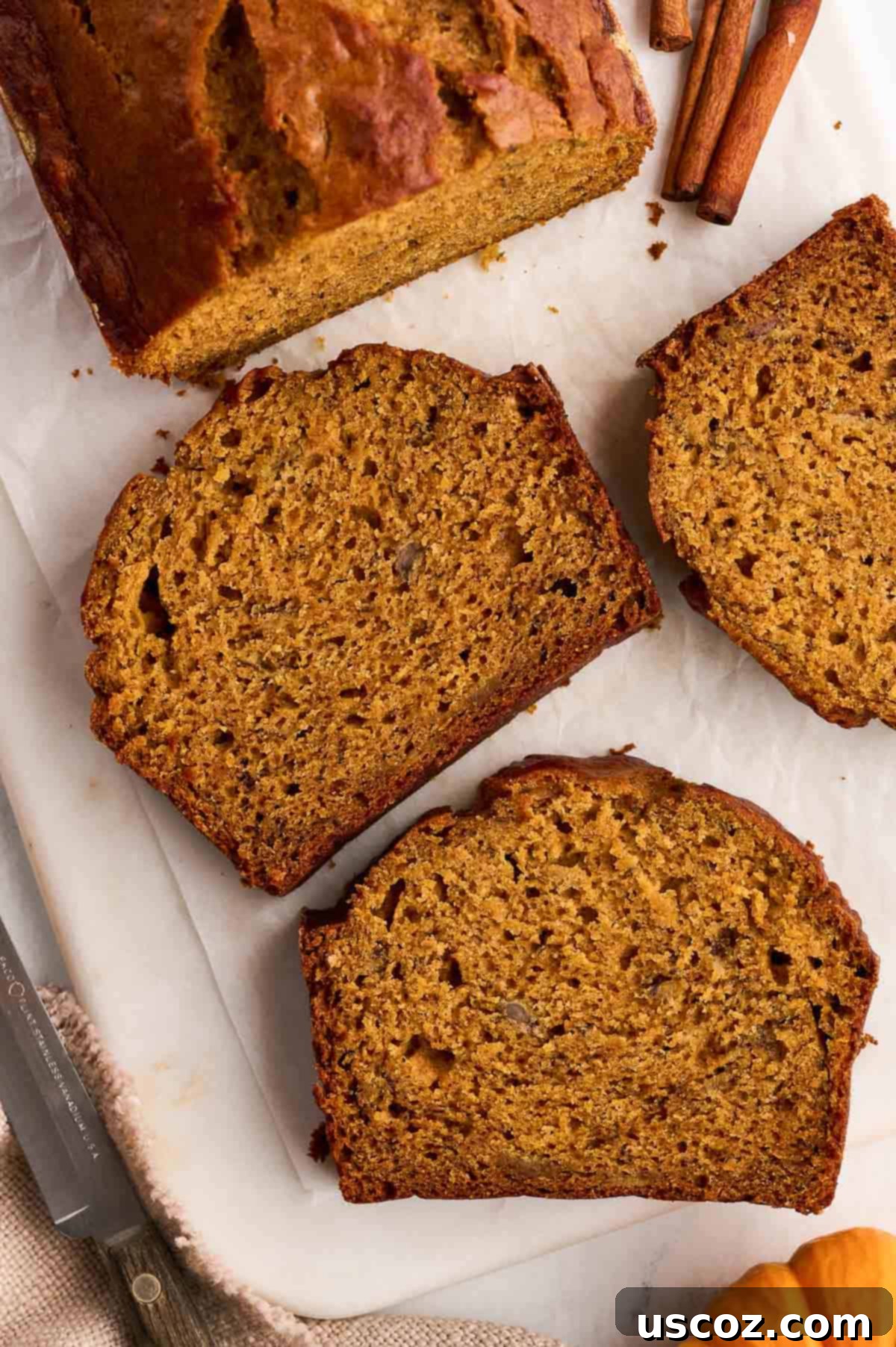 Close-up of several slices of pumpkin banana bread, highlighting the beautiful color and texture
