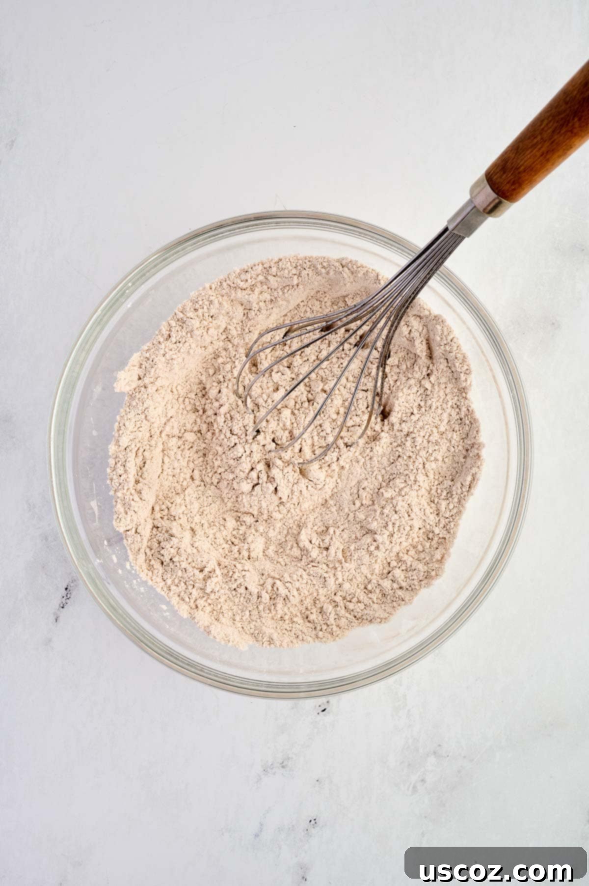 Dry ingredients whisked together in a mixing bowl, ready to be combined with the wet ingredients