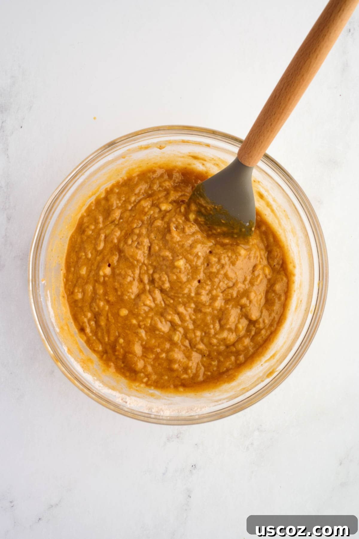 Pumpkin banana bread batter mixed together, showing a smooth and slightly thick consistency
