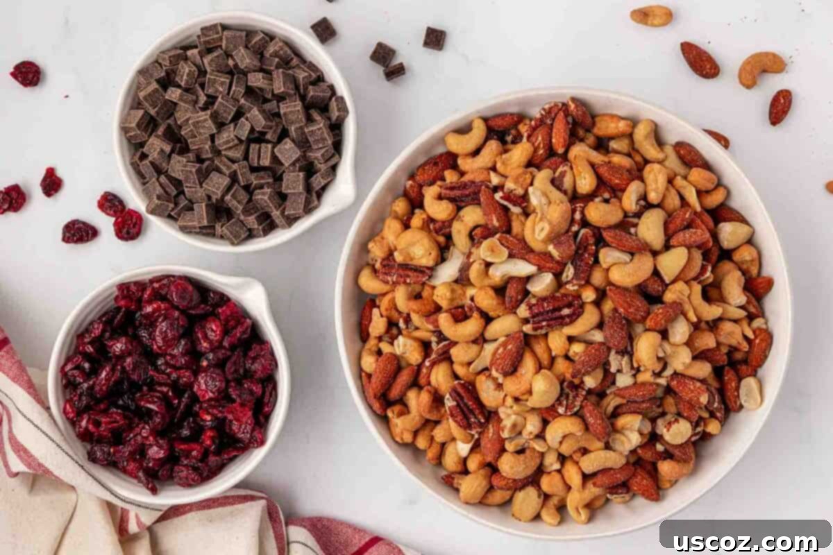 The Ultimate Guide to Crafting Your Own Trail Mix 5 Three bowls containing roasted nuts, cranberries, and chocolate chunks